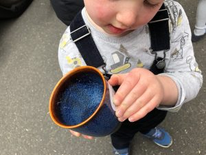 Boy with ceramic cup in his hand